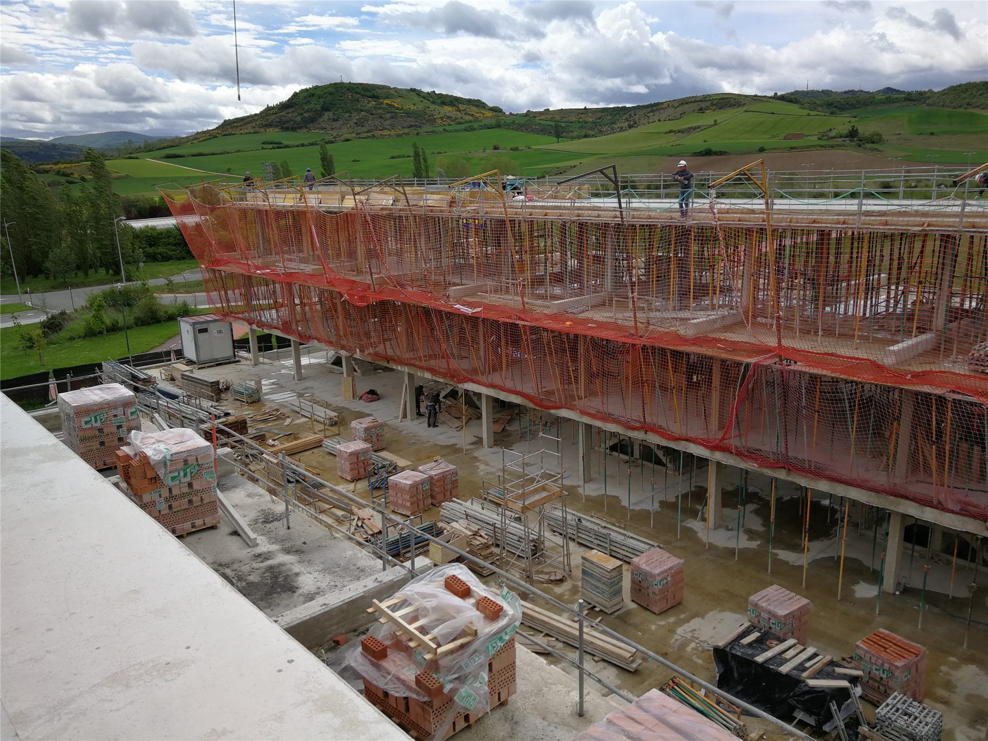 Obra en ejecución de un edificio con estructura de hormigón y andamios de seguridad
